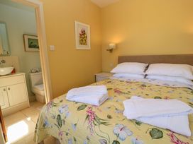 A bedroom with bed and bathroom at Pheasant Cottage in Priston Village, BATH
