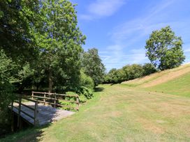 An outdoor area with a bridge and trees at Pheasant Cottage, Priston Village, BATH