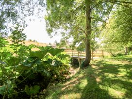 A view of a bridge surrounded by greenery at Pheasant Cottage in Priston Village, BATH