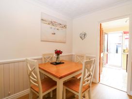 A dining room with a table and chairs at Breydon Cottage in Bradwell near Gorleston-On-Sea