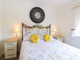 A bedroom with a bed and bedside lamps at Breydon Cottage in Bradwell near Gorleston-On-Sea