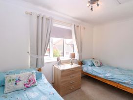 A bedroom with two beds and a window at Breydon Cottage, Bradwell near Gorleston-On-Sea
