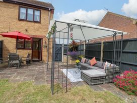 A garden with outdoor seating and a patio at Breydon Cottage in Bradwell near Gorleston-On-Sea