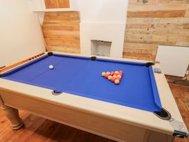 A pool table with arranged balls in a game room at Labour in Vain St Ives