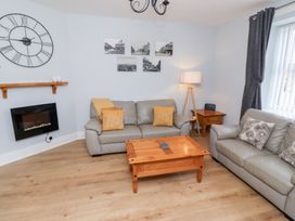 A living room with sofas and a coffee table at Hasting Dairy in North Sunderland near Seahouses