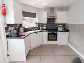 A kitchen with an oven, sink, and dishwasher at Hasting Dairy in North Sunderland near Seahouses