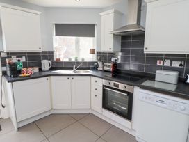 A kitchen with appliances and cupboards at Hasting Dairy in North Sunderland near Seahouses