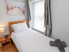 A bedroom with a single bed and window at Hasting Dairy in North Sunderland near Seahouses