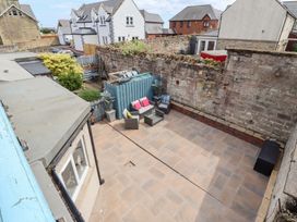 A garden with seating area and plants at Hasting Dairy in North Sunderland near Seahouses