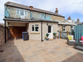 An outdoor area with a balcony and seating at Hasting Dairy in North Sunderland near Seahouses