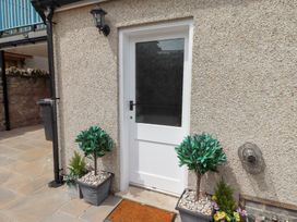 An outdoor area with a door and planters at Hasting Dairy in North Sunderland near Seahouses