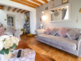 A living room with a sofa and coffee table at Woodland Cottage in Garth
