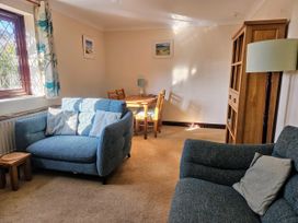 A living room with a sofa and table at Chiffchaff in Padstow