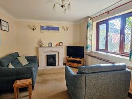 A living room with a fireplace and television at Chiffchaff in Padstow