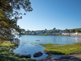A view of a harbor with houses along the shoreline at Bay View Apartment in Porthmadog