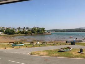 A view of water with boats and houses at Bay View Apartment in Porthmadog