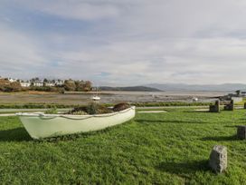 A boat on grass near water at Bay View Apartment in Porthmadog