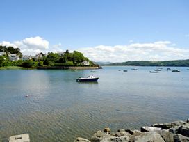 A view of water with boats and houses at Bay View Apartment in Porthmadog