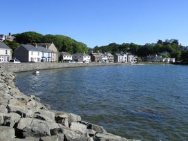 A view of a waterfront with buildings and trees at Bay View Apartment Porthmadog