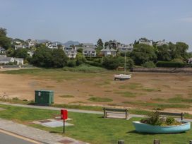 A view of houses and a boat by the water at Bay View Apartment in Porthmadog