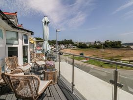A balcony with chairs and a table at Bay View Apartment in Porthmadog