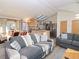 A living room and kitchen area with a sofa and dining table at Heights View