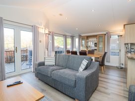A living room with a sofa and dining area at Heights View