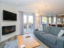 A living room with a television and fireplace at Heights View