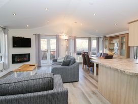 A living room with a fireplace and dining table at Heights View