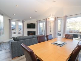 A dining room with a sofa and a dining table at Heights View
