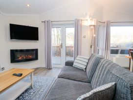 A living room with a television and fireplace at Heights View