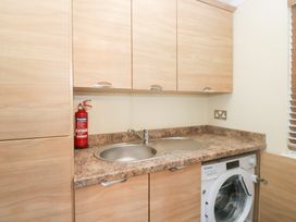 A laundry room with a sink and washing machine at Heights View
