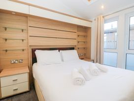 A bedroom with a bed and nightstand at Heights View