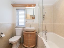 A bathroom with a toilet, sink, and bathtub at Heights View