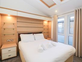 A bedroom with a bed and windows at Heights View