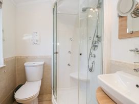 A bathroom featuring a shower, toilet, and sink at Heights View