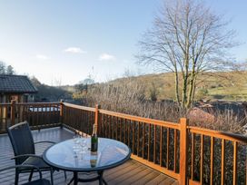 An outdoor deck with a table and chairs at Heights View