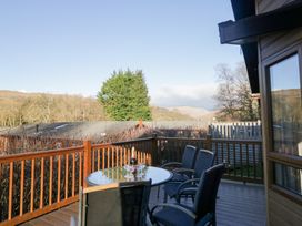 An outdoor deck with a table and chairs at Heights View in 