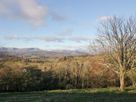 A landscape with mountains, trees, and fields at Heights View 