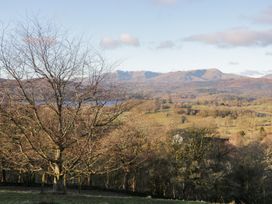 A view of mountains and a tree near a body of water at Heights View