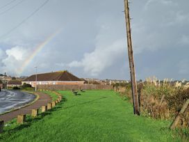 A landscape with a rainbow and benches at The Lookout -The House With A View Weymouth