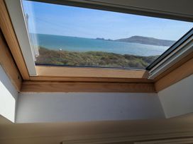A view of the sea and hills through a skylight at The Lookout -The House With A View in Weymouth