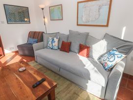 A living room with a sofa and armchair at Kernyk in Penzance