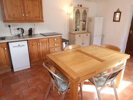 A kitchen with a table and chairs at Kernyk in Penzance