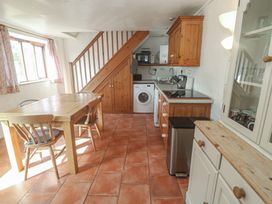 A kitchen with a table and chairs at Kernyk in Penzance