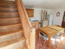 A kitchen with a dining table and chairs at Kernyk in Penzance