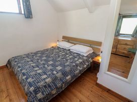 A bedroom with a bed and nightstand at Kernyk in Penzance