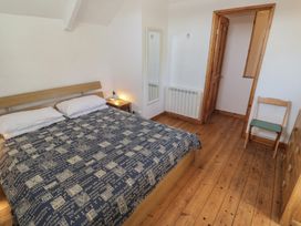 A bedroom with a bed and nightstand at Kernyk in Penzance
