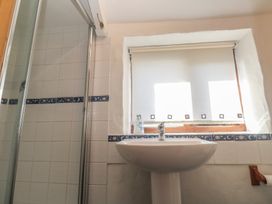 A bathroom with a shower and a sink at Kernyk in Penzance