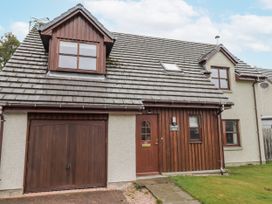 A house with a garage and front door at Burnside House in Aviemore